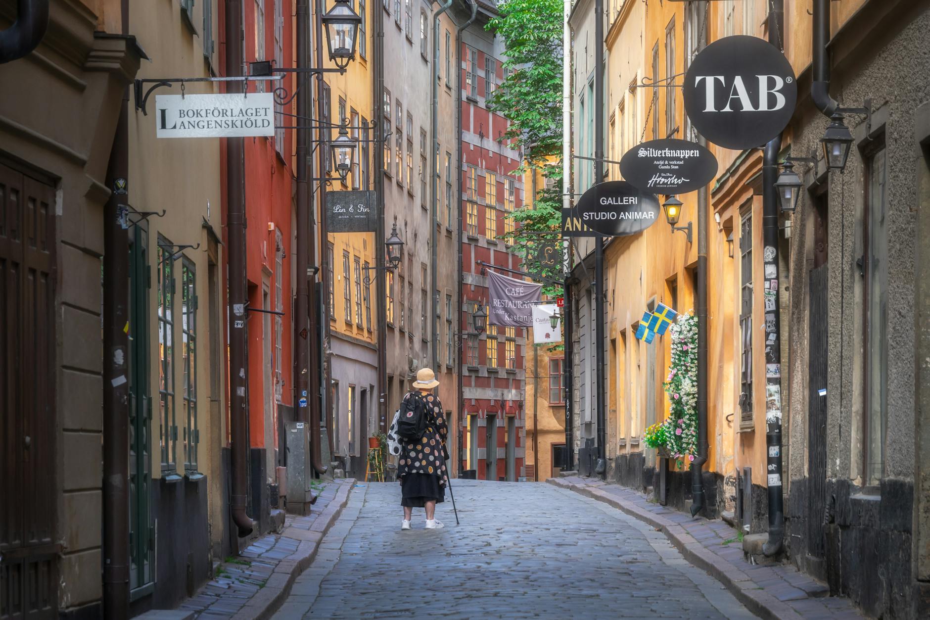 Spacerujący turysta na wąskiej uliczce Gamla Stan w Sztokholmie